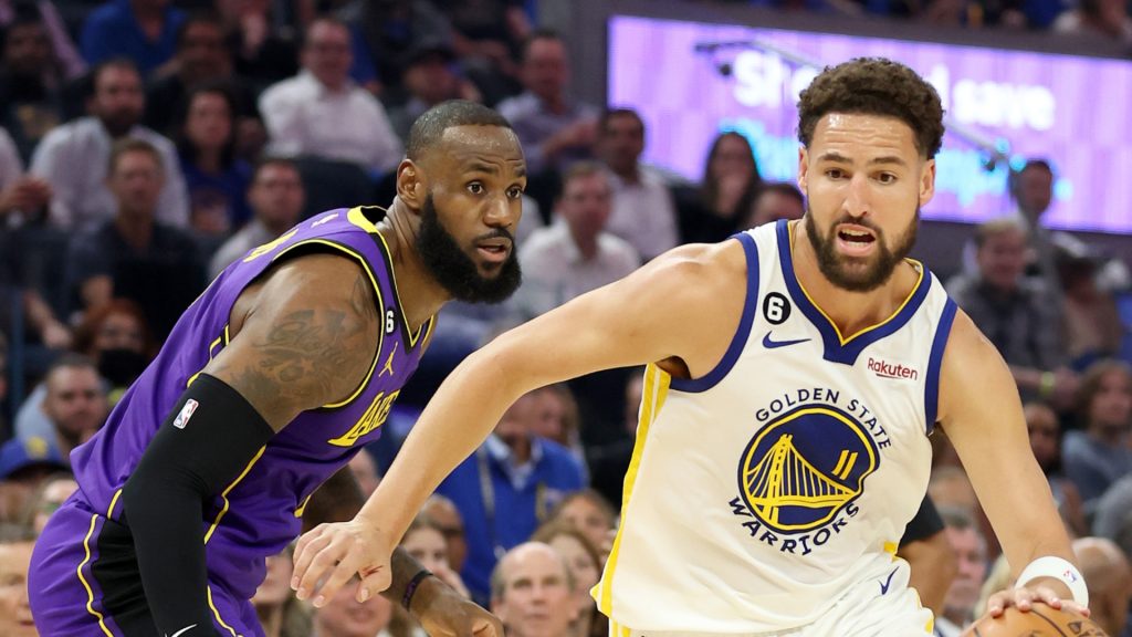 Klay Thompson #11 of the Golden State Warriors dribbles past LeBron James #6 of the Los Angeles Lakers at Chase Center on October 18, 2022 in San Francisco, California.
