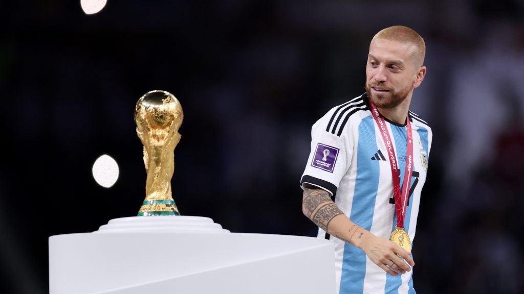Alejandro Gomez of Argentina walks past the The FIFA World Cup Qatar 2022 Winner’s Trophy after the team’s victory during the FIFA World Cup Qatar 2022 Final match between Argentina and France at Lusail Stadium on December 18, 2022 in Lusail City, Qatar.