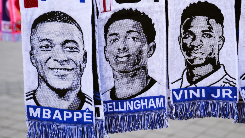 Scarves of Kylian Mbappe, Jude Bellingham and Vinicius Jr.hang in a souvenir stall outside the stadium prior to the UEFA Champions League 2023/24. Photo by David Ramos/Getty Images