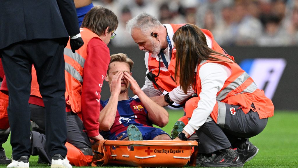 Frenkie de Jong of FC Barcelona is placed onto a stretcher after suffering an injury during the LaLiga EA Sports match between Real Madrid CF and FC Barcelona. David Ramos/Getty Images
