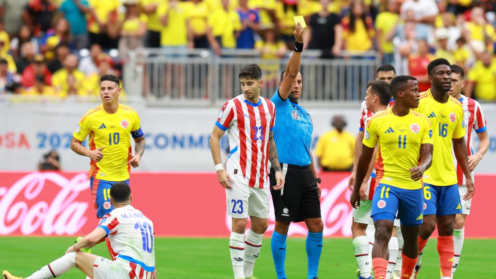 Referee Dario Humberto Herrera shows a yellow card to Jefferson Lerma of Colombia during the CONMEBOL Copa America 2024 Group D match between Colombia and Paraguay. Hector Vivas/Getty Images